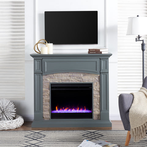 Image of Color changing fireplace w/ stacked faux stone surround Image 1